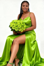 Load image into Gallery viewer, Woman in a green satin dress holding a bouquet of green roses on a white background