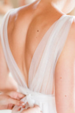 Load image into Gallery viewer, Close-up of a person wearing a white dress with a blurred background