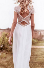 Load image into Gallery viewer, Woman wearing a white dress with lace detailing outdoors.