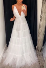 Load image into Gallery viewer, Woman in a white wedding dress standing in front of a mirror.
