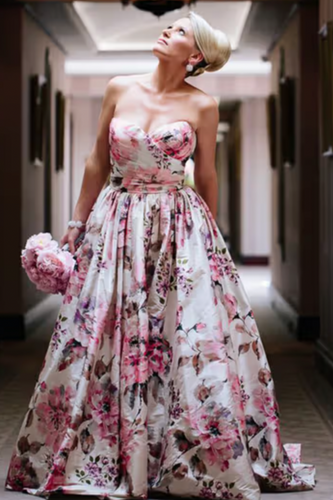 Woman in a floral dress standing in a hallway