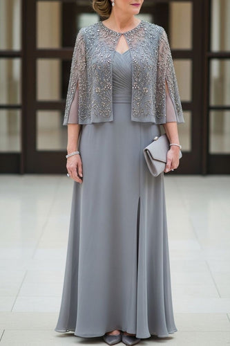 Woman wearing a gray dress with a matching jacket indoors.