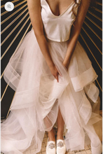 Load image into Gallery viewer, Person wearing a white dress with a high-low hem on a patterned floor.