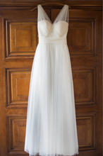 Load image into Gallery viewer, White wedding dress hanging on a wooden door