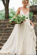 Laden Sie das Bild in den Galerie-Viewer, Woman in a white dress holding flowers on stone steps